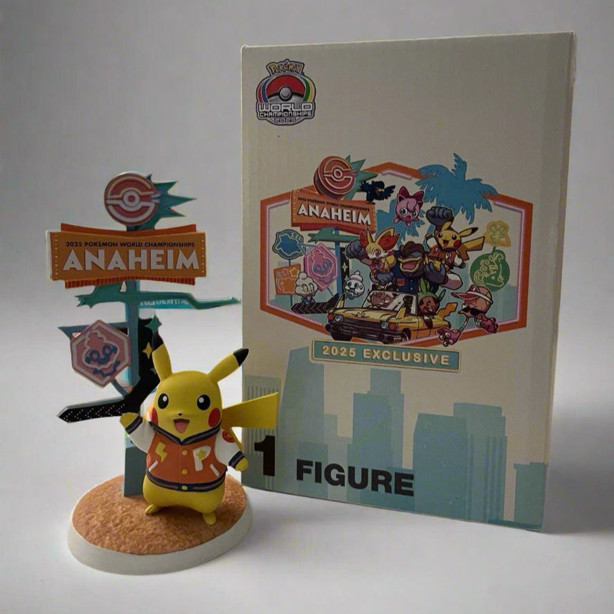 Pikachu figure wearing a varsity jacket next to a 2025 Anaheim World Championships sign and illustrated display box.