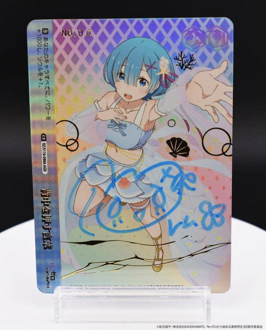 Weiss Schwarz Re:ZERO Rem AGR autograph card with a blue foil signature, holographic finish, and anime character art.