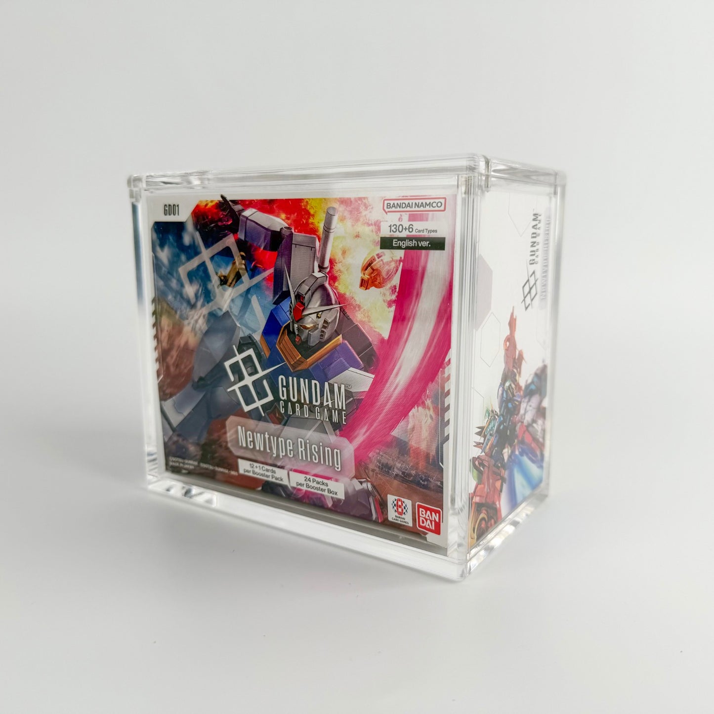 Clear acrylic display case protecting a Gundam Card Game booster box.