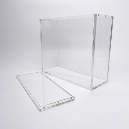 Clear acrylic display case for TCG booster boxes with a magnetic, removable top lid on a white background.