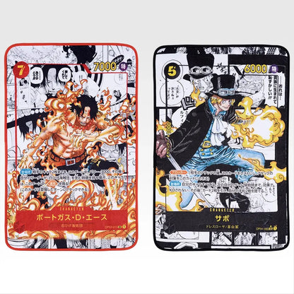 Two 60x90cm One Piece card blankets featuring full-color illustrations of Ace with flames and Sabo in his top hat.