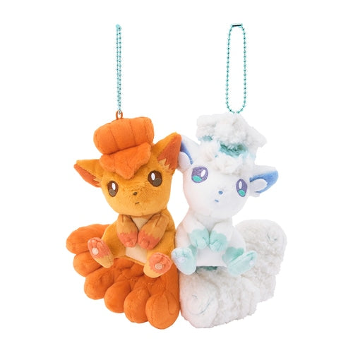 Orange Vulpix and white Alolan Vulpix plushies with magnetic bodies and blue ball chains for hanging.