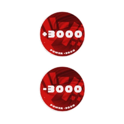Two round red acrylic One Piece Card Game tokens, one showing "+3000 Power" and the other "-3000 Power".