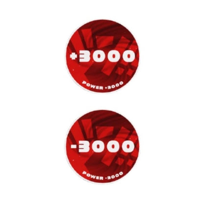 Two round red acrylic One Piece Card Game tokens, one showing "+3000 Power" and the other "-3000 Power".