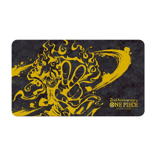 One Piece 2nd Anniversary rubber playmat featuring a gold Luffy Gear 5 illustration on a black textured background.