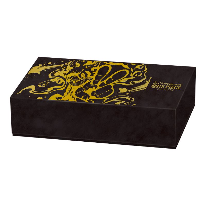 Black cardboard One Piece 2nd Anniversary storage box featuring gold Luffy Gear 5 artwork and logo.