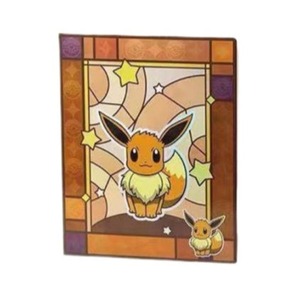 Pokémon 9-pocket card binder featuring a stained-glass Eevee design with warm orange and purple tones and star accents.