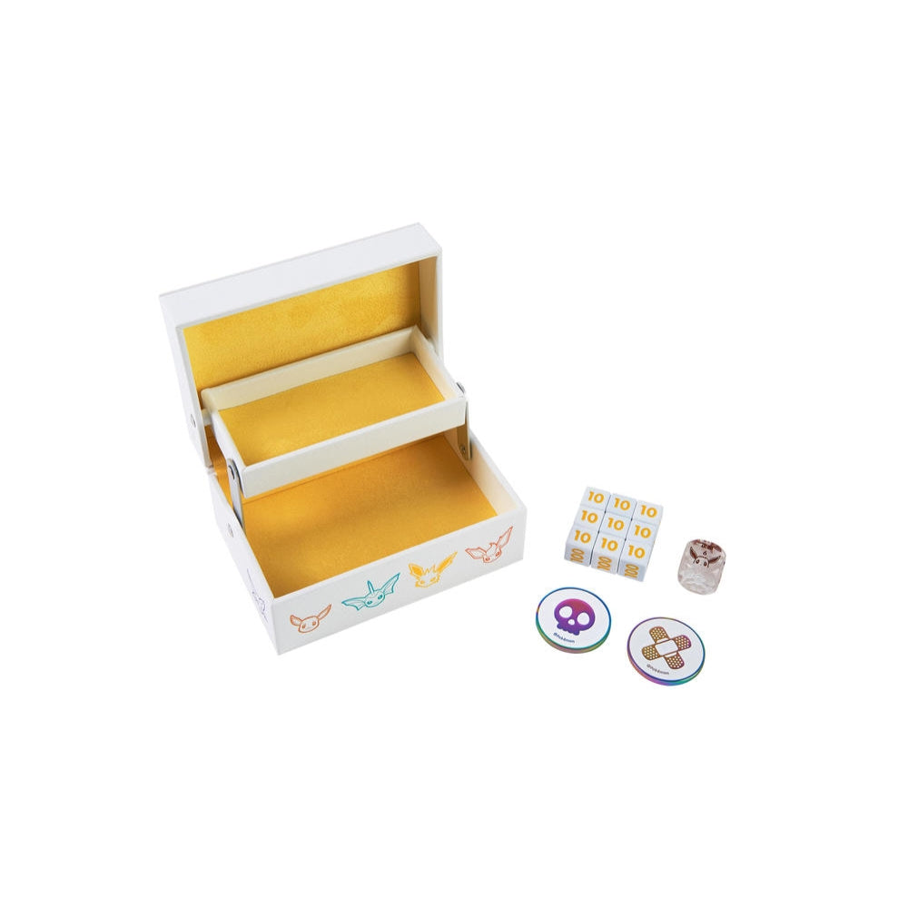 White Eeveelution storage box with yellow interior, metal damage dice, Eevee acrylic die, and two condition markers.