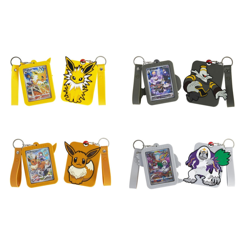 Four sets of Pokémon blind box displays: yellow Jolteon, dark gray Dusknoir, orange Eevee, and light gray Slaking silicone keychains.