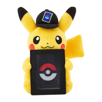 Yellow Pikachu plush wearing a black cap and holding a vertical black display stand for a Pokémon trading card.