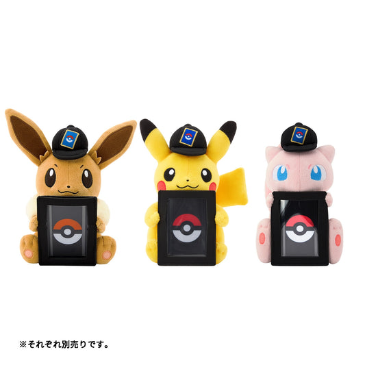 Eevee, Pikachu, and Mew plush card stands wearing black caps and holding vertical black Pokémon card display frames.