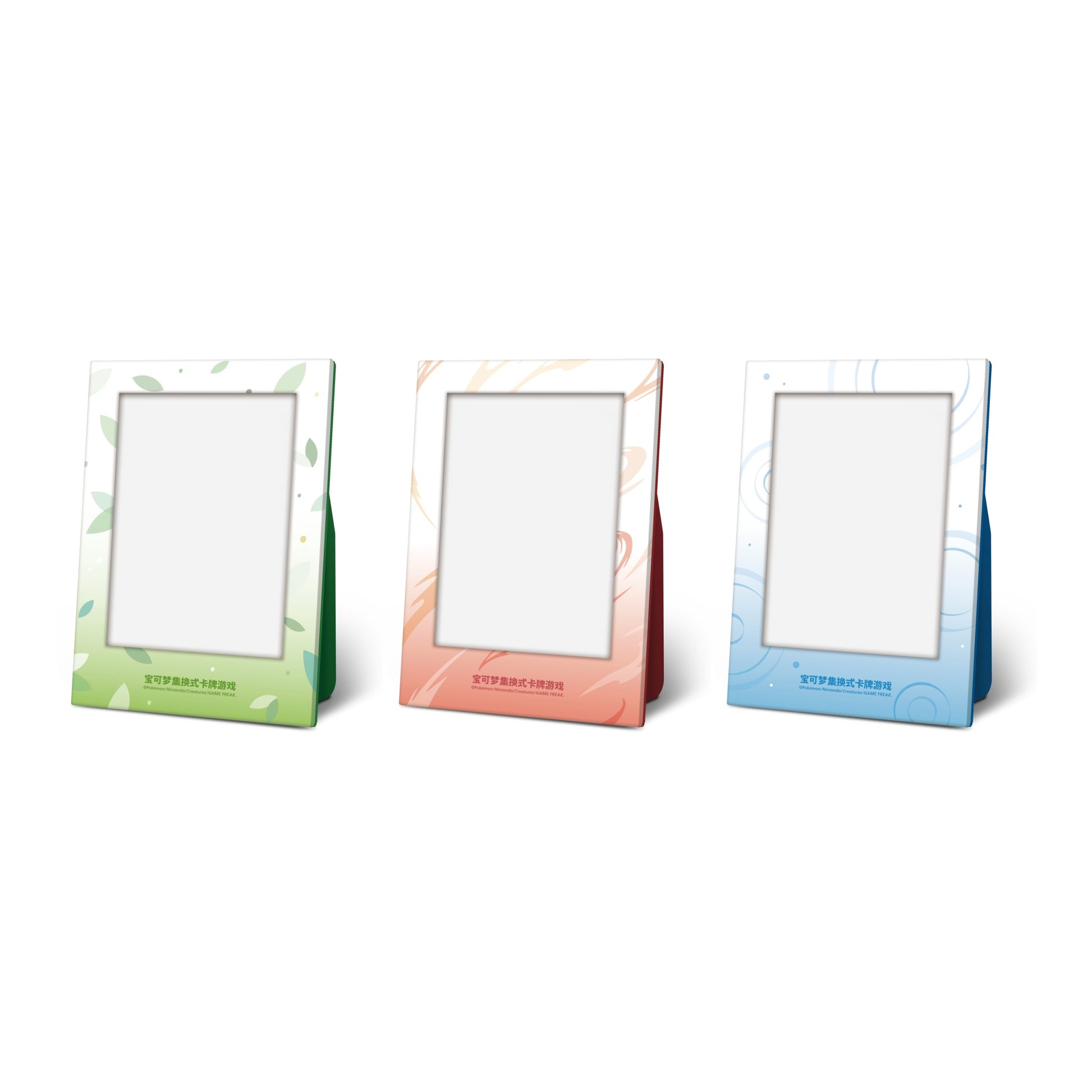 Three Pokémon 151 acrylic display stands in green, orange, and blue with themed patterns and Simplified Chinese text.