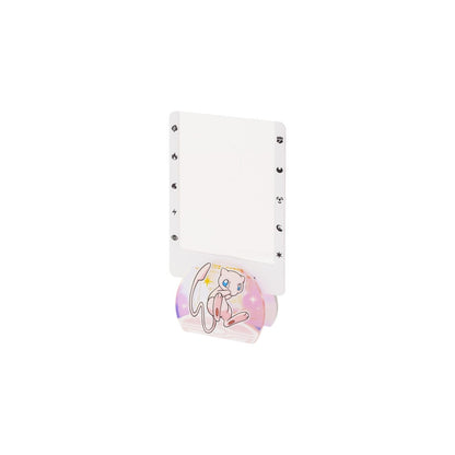 Pokémon 151 Journey acrylic stand featuring a pink Mew character design with energy symbols on a white rectangular frame.