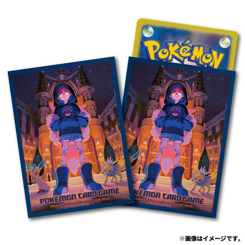Two blue Pokémon Card Game sleeves featuring Cassiopeia, a character in a blue hoodie and glasses, with Sylveon and Jolteon. One sleeve holds a Pokémon card.