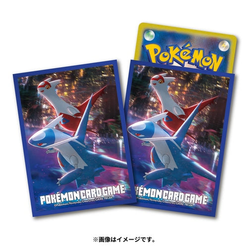 Two blue Pokémon card sleeves featuring Latias and Latios flying against a night city view. One sleeve holds a Pokémon card.