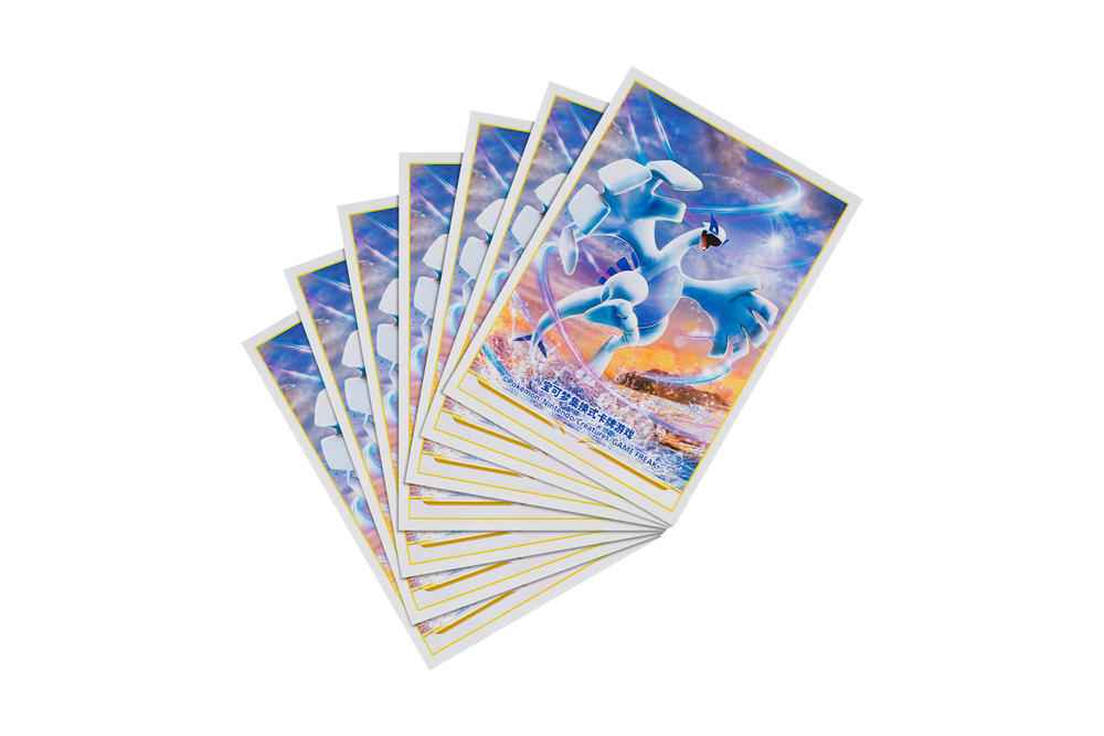 Fan of Pokémon card sleeves featuring a blue Lugia illustration on a glossy, protective plastic finish.