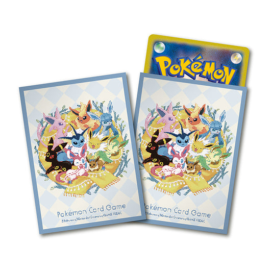 Two Pokémon Card Game sleeves with Terastal Eeveelution art, one holding a Pokémon card.