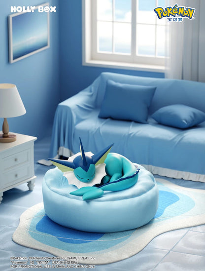 Vaporeon figure sleeping on a soft, light blue beanbag cushion in a cozy, blue-themed bedroom setting.