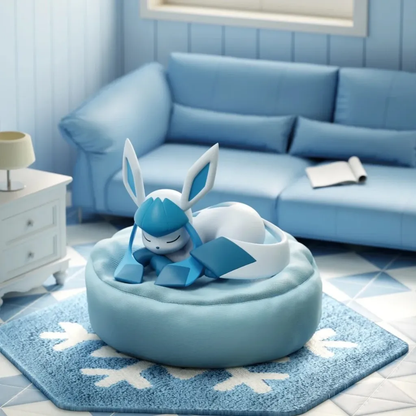 Glaceon sleeping figure resting on a soft, round blue beanbag cushion in a cozy, blue-themed living room setting.