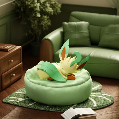 Leafeon sleeping figure resting on a soft, round green beanbag cushion in a cozy, leaf-themed living room setting.