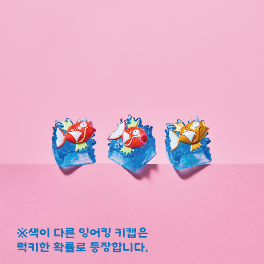 Three Magikarp Pokémon keycaps featuring red and gold fish figures atop translucent blue water-textured bases.