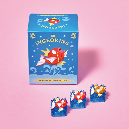 Blue Pokémon Magikarp blind box with three artisan keycaps featuring red and gold fish designs on blue water bases.