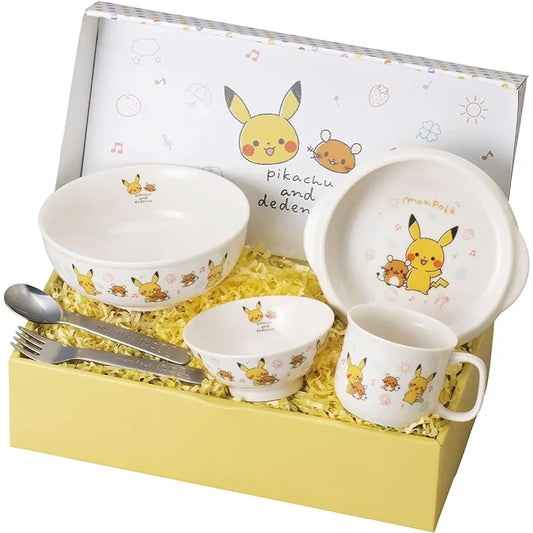 White ceramic Pokémon Monpoke tableware gift set with Pikachu and Dedenne designs, including bowls, mug, plate, and stainless steel utensils in a yellow box.