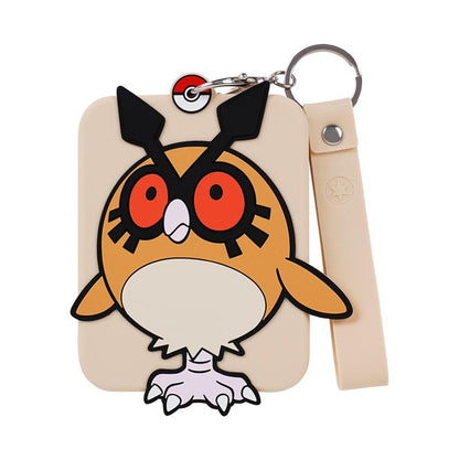 Beige silicone Pokémon display with a colorful Hoothoot design, metal keychain, and matching strap.