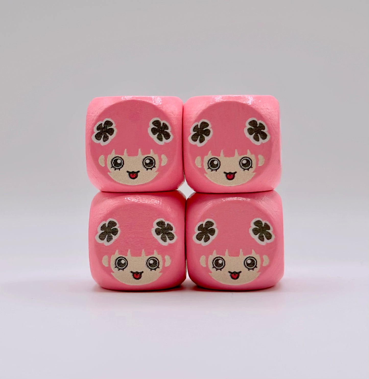 Four pink 16mm wooden TCG dice with rounded corners and a custom anime-style character design on the face.