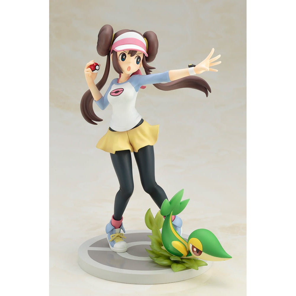 Kotobukiya Rosa with Snivy 1/8 scale PVC figure. Brown-haired Rosa in white, blue, and yellow outfit, holding a Poké Ball. Green Snivy at her feet.